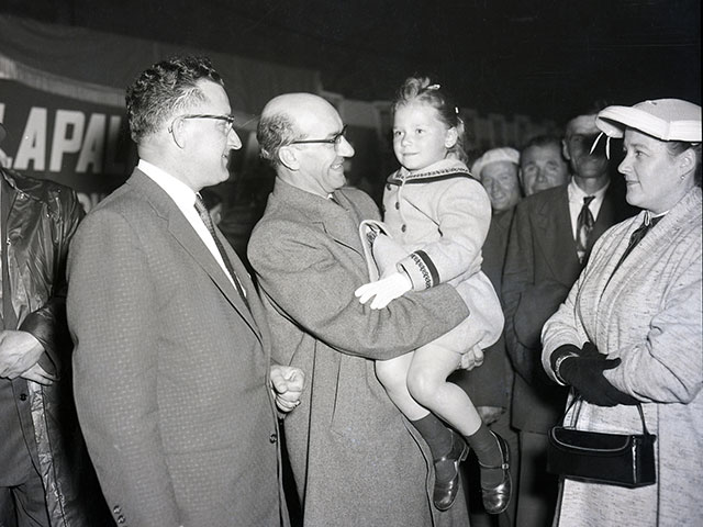 Georges-Émile Lapalme holding a young girl in his arms