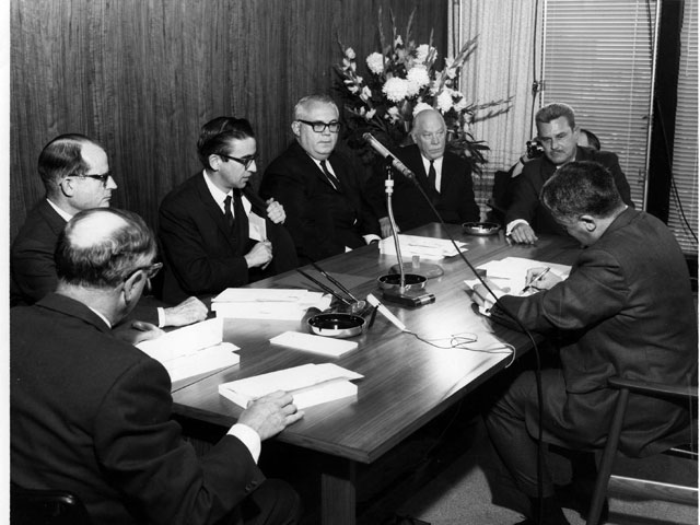 Mr. Prieur, surrounded by representatives of both groups of electricity producers during Signature of an agreement