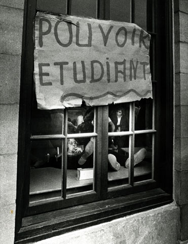 A sheet of paper featuring words is glued to the window of a room